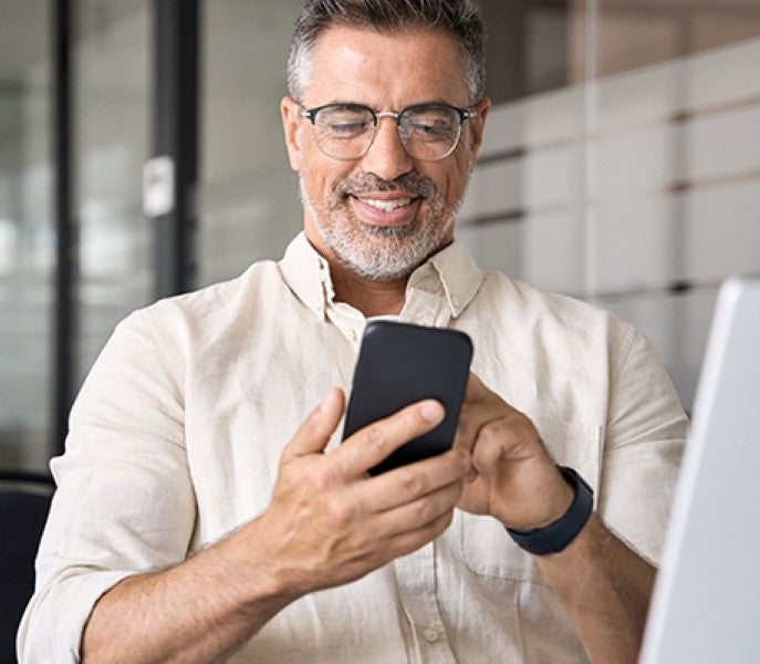 man dialing a cell phone