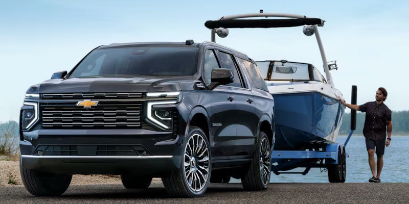 2025 Chevrolet Suburban pulling boat out of lake